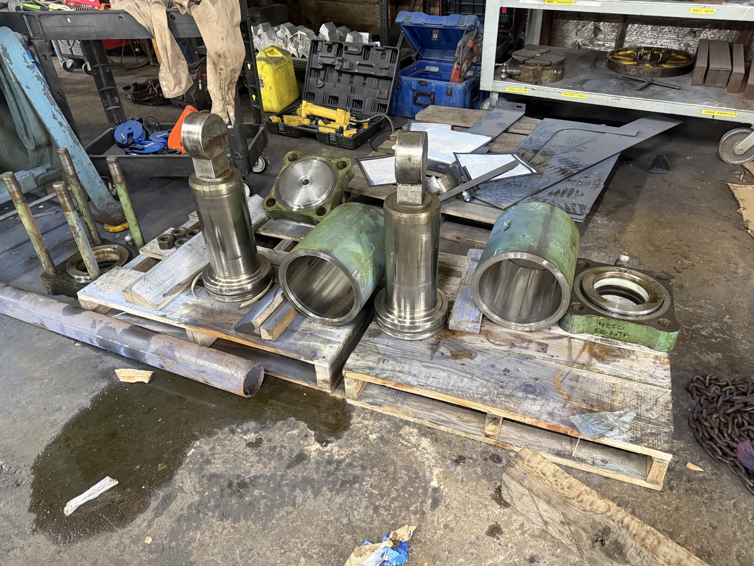 Disassembled hydraulic cylinders and components